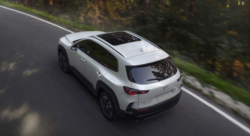 2026 Mazda CX-50 Hybrid Driving Near Woods