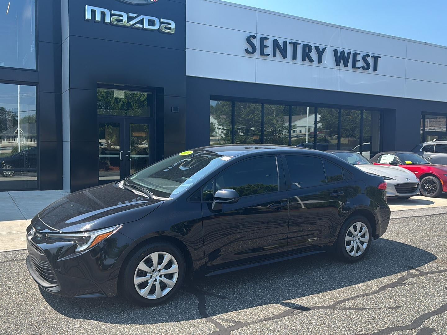2023 Toyota Corolla Hybrid LE in Midnight Black Metallic — front three-quarter view